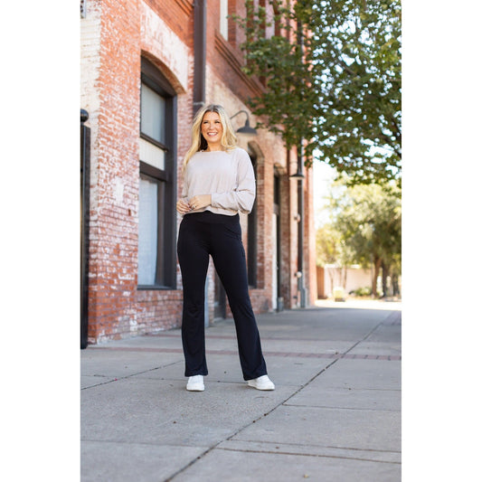 High-waisted black bootcut leggings by Julia Rose, Julia Rose women’s flared black leggings lifestyle image